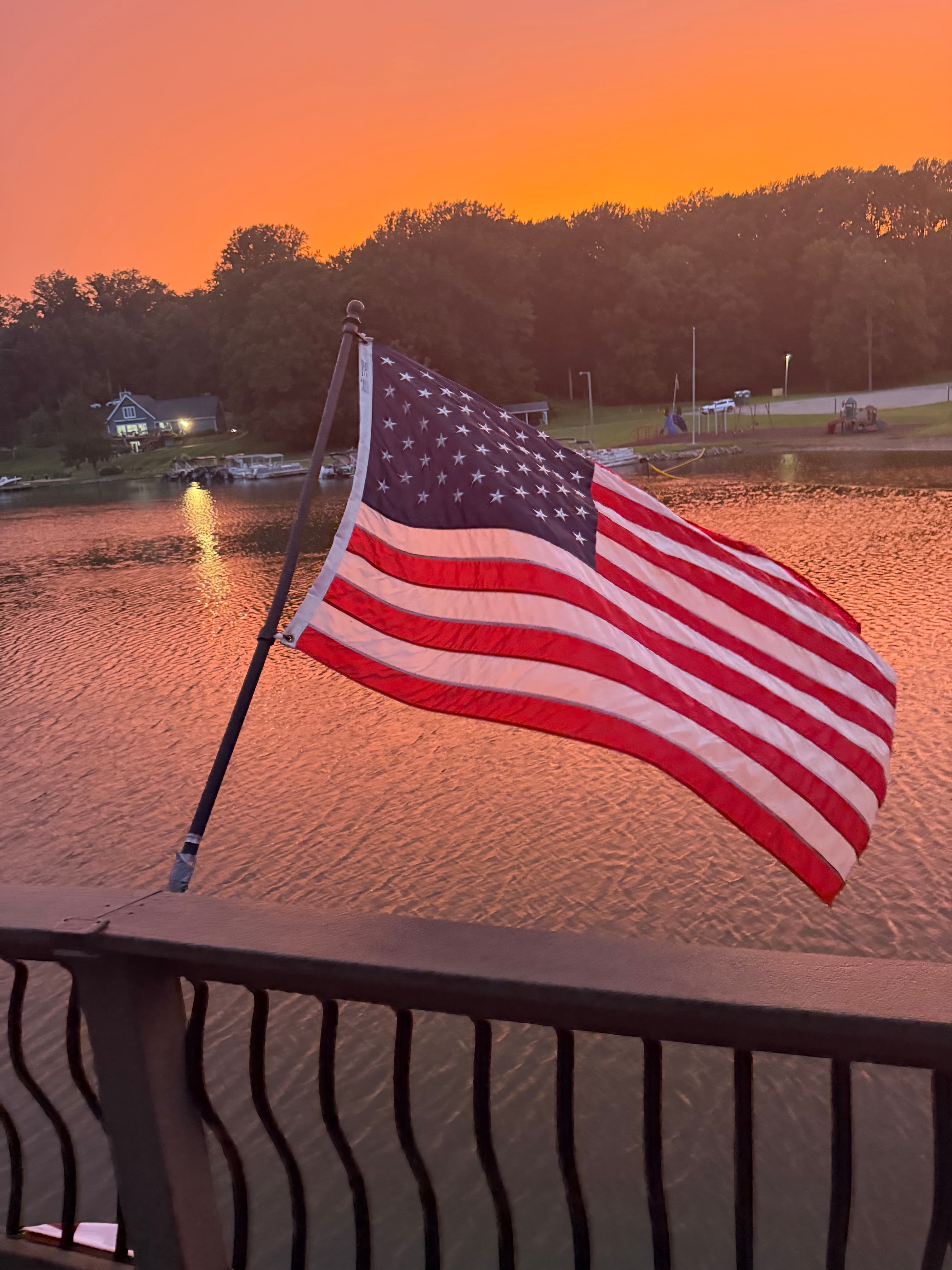 American flag at sunset over the lake